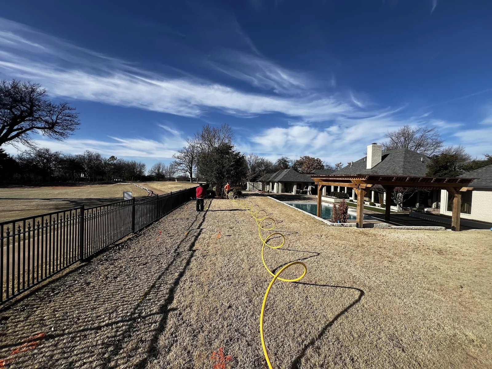 Crew Member Residential Bore Dallas HDD Contractors Bore rig and conduit reels staged on a commercial drilling site