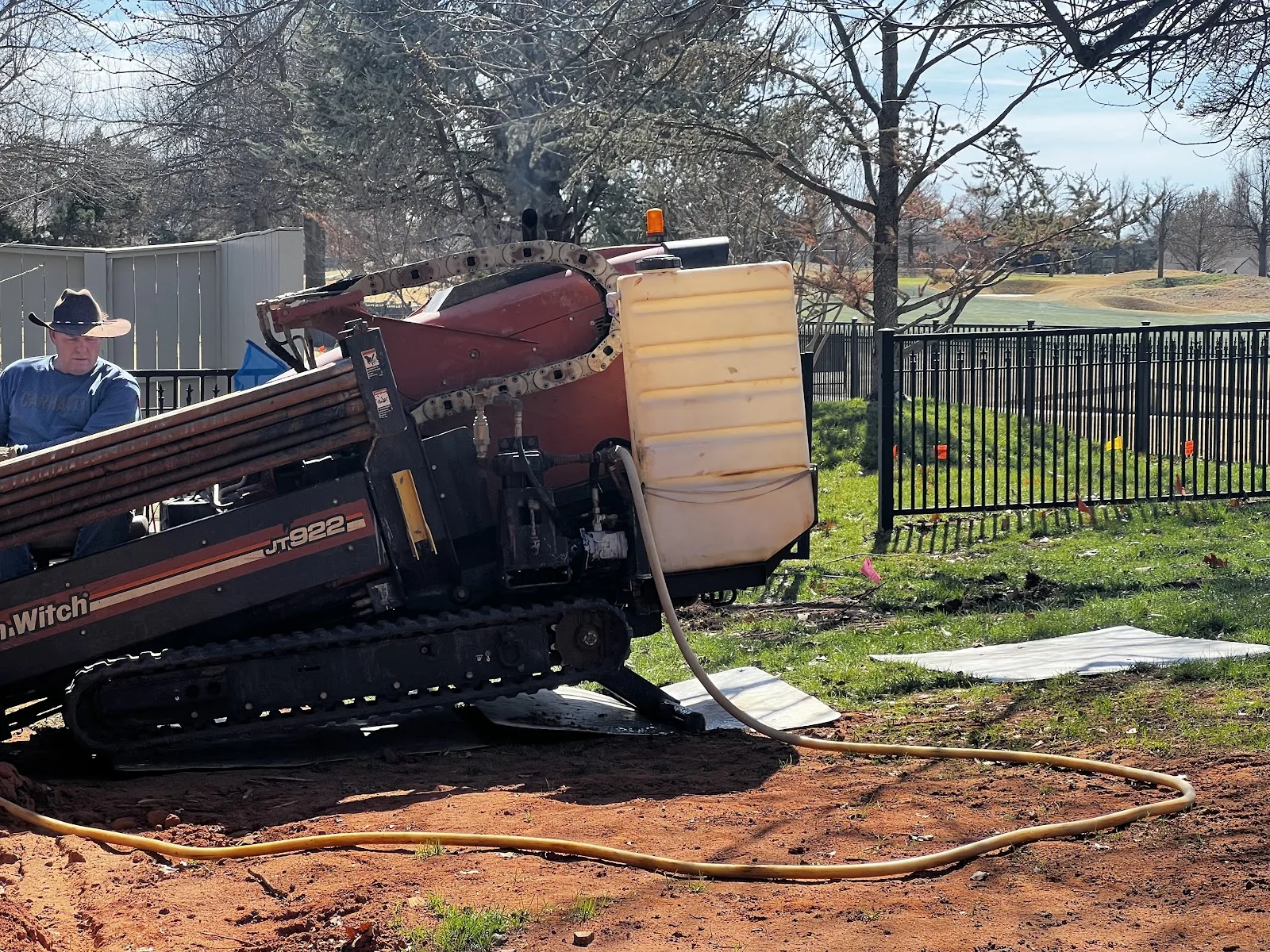 Track Field Utility Boring Texas Dallas HDD Contractors Crew pulling HDPE pipe back through a completed bore