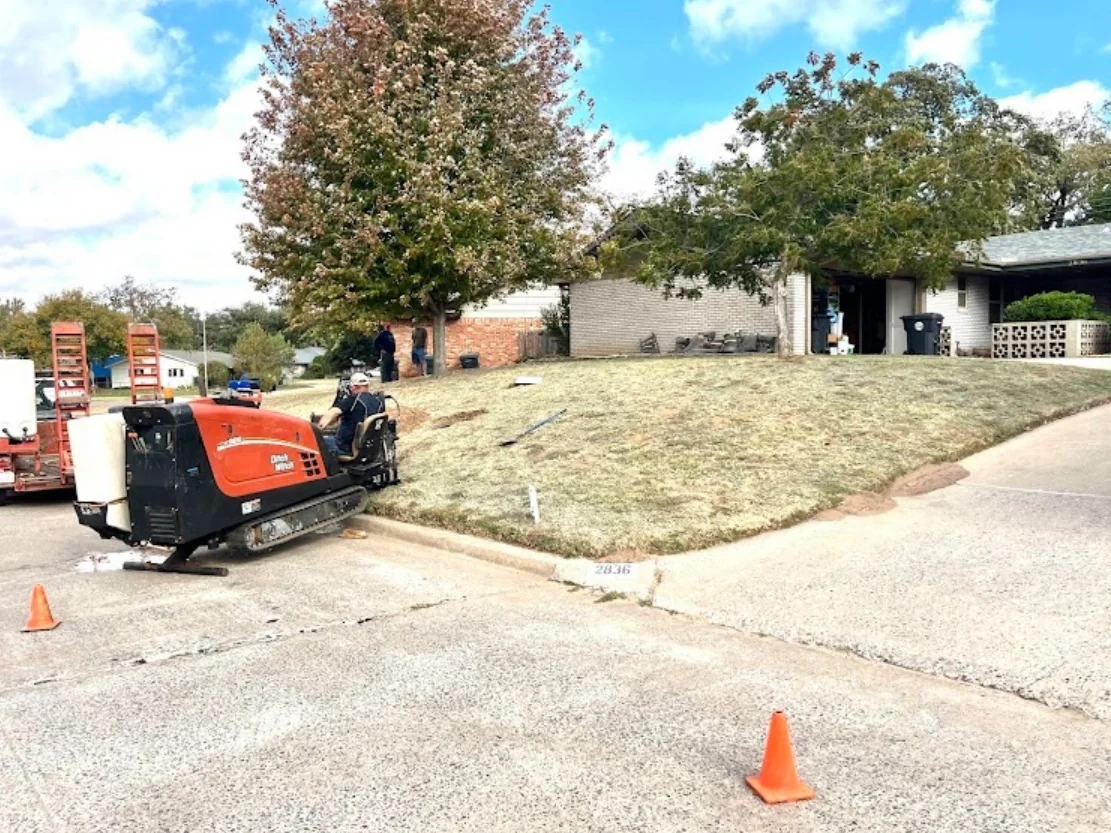 University Campus Bore Sidewalk Dallas Texas Dallas HDD Contractors Excavator clearing a bore pit on an active directional drilling site