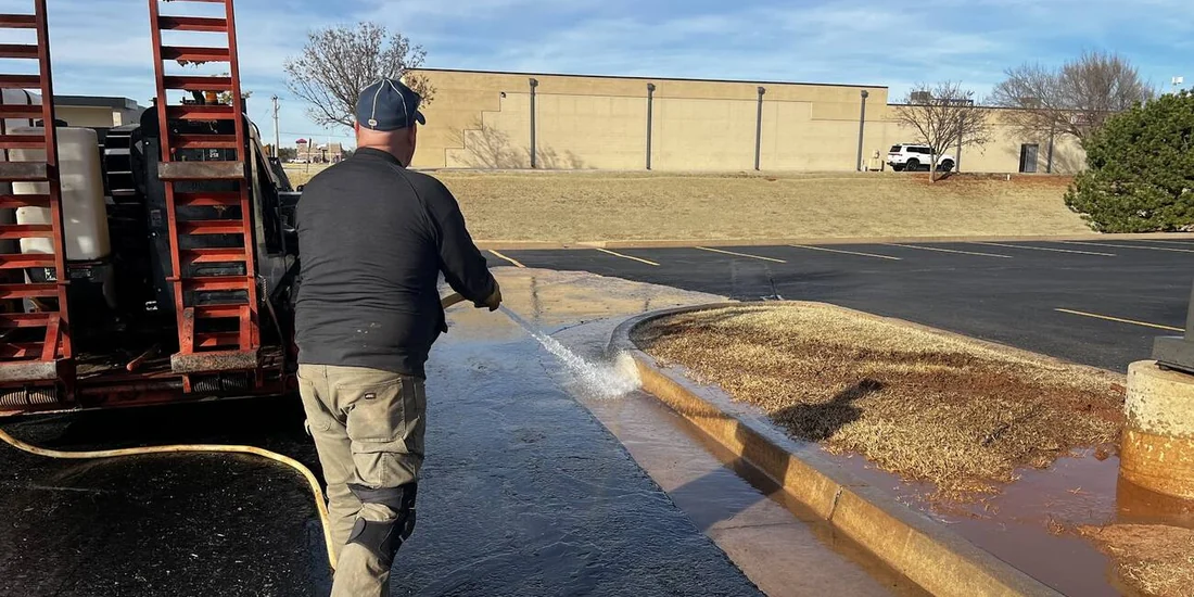 Hydrovac unit daylighting a utility line along a curb line before boring