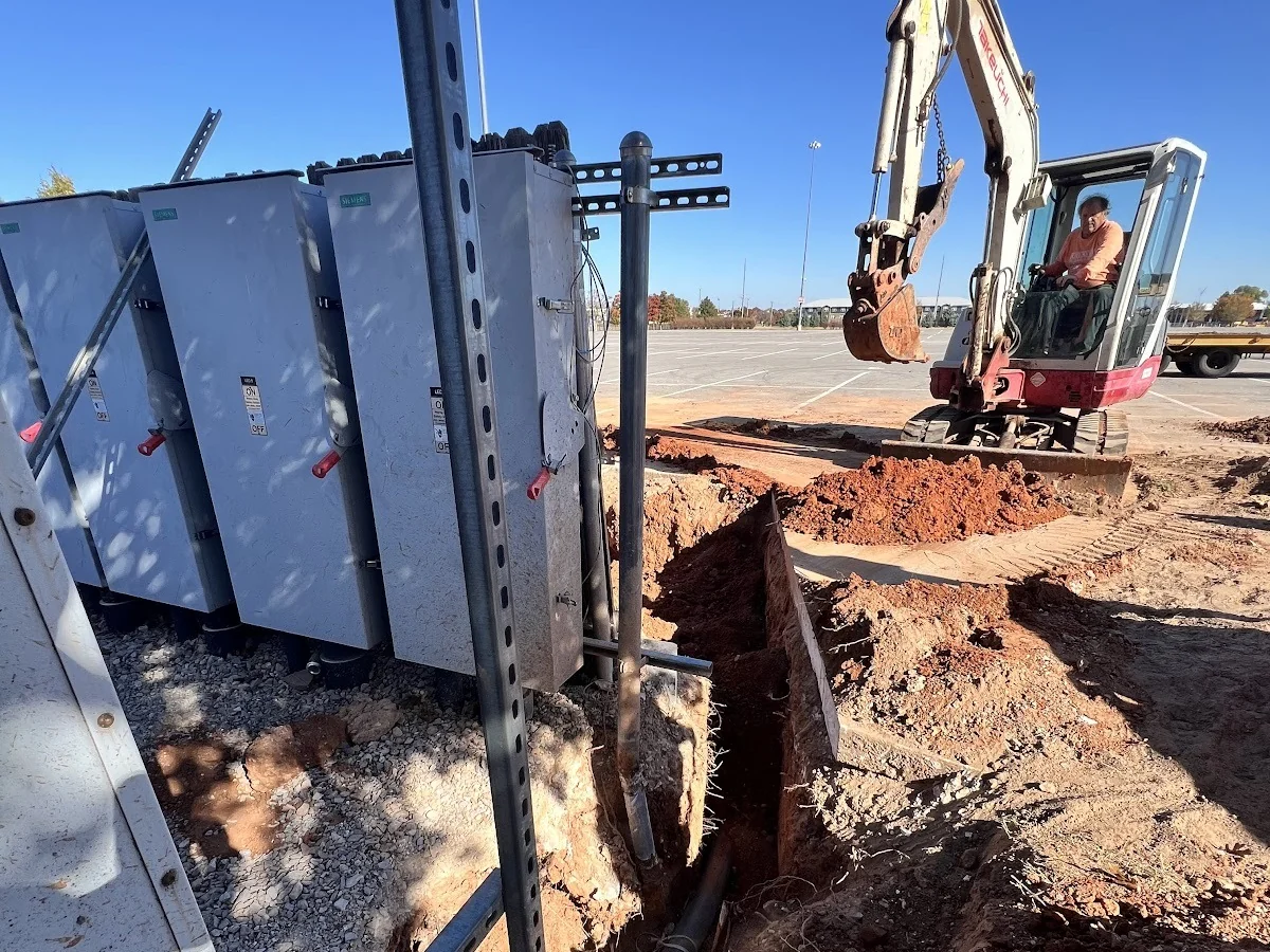 Mini Excavator Trench H-Beam Dallas HDD Contractors Pipe pullback in progress at the exit pit of a directional bore